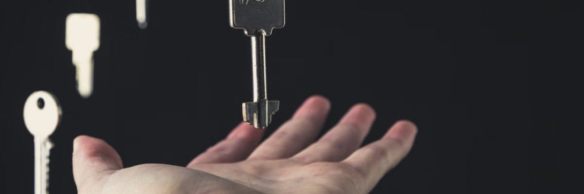 A mysterious scene of keys floating above an open hand against a dark background.